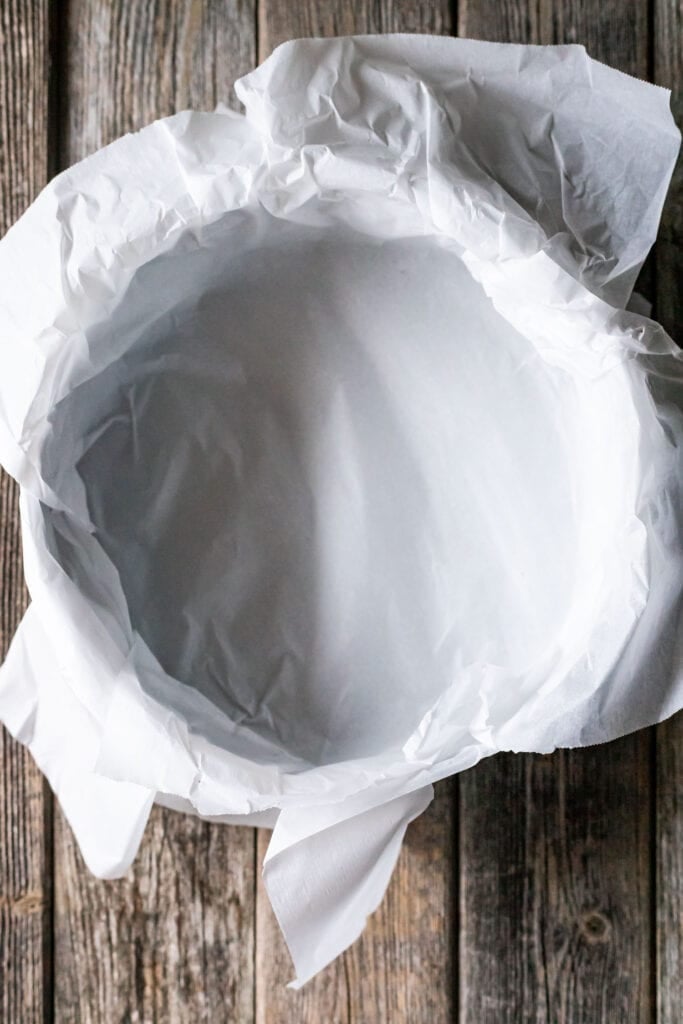 Parchment paper lining a 9 inch springform pan.