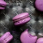 Ube macarons on a silver pan.