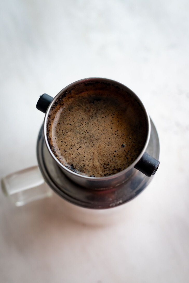 Vietnamese coffee filter on a coffee cup.
