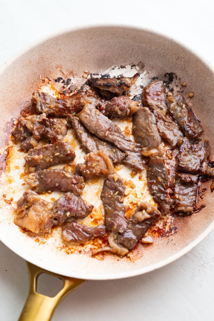 Steak seared on both sides in a fry pan.