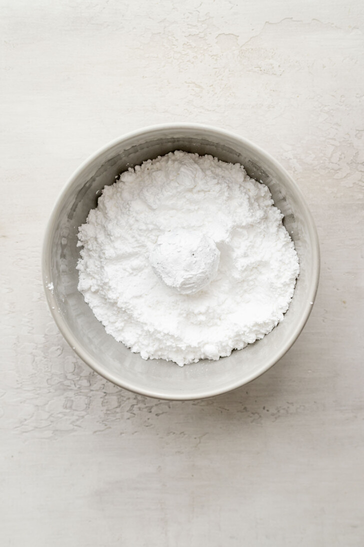 Matcha cookie dough rolled in powdered sugar