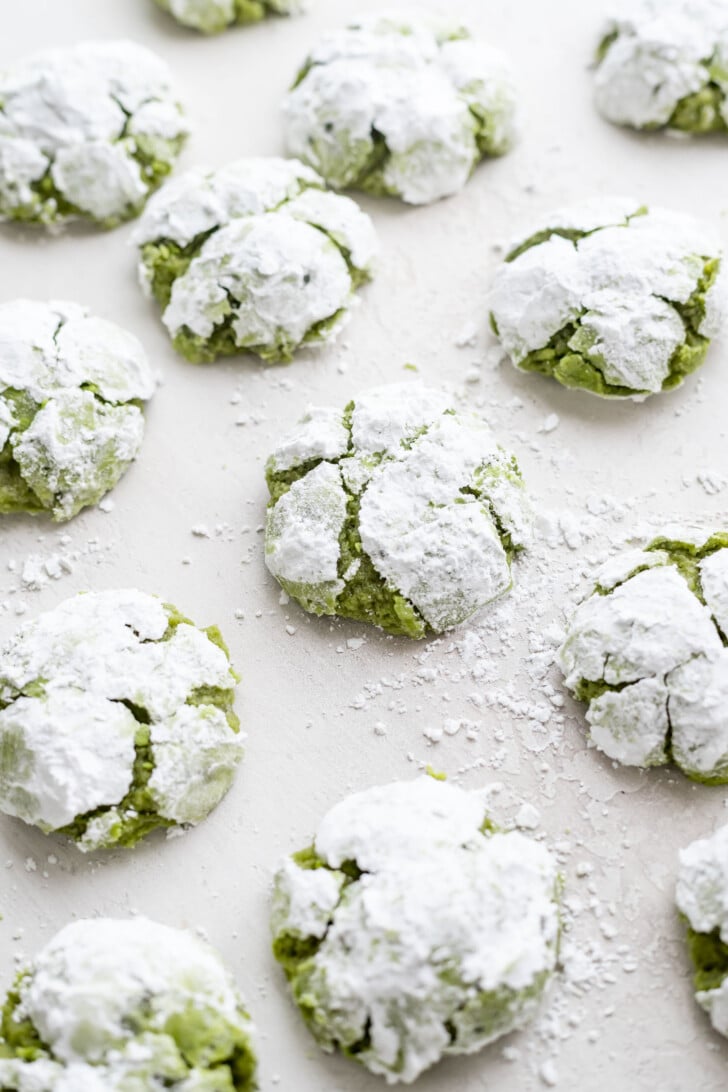 Matcha crinkle cookies on a white table
