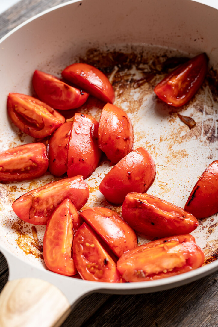 Sauteed tomatoes in a saute pan.