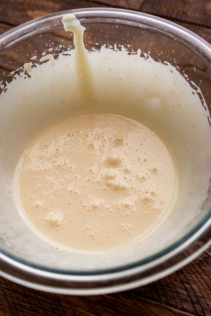 Whipped egg yolk and condensed milk in a mixing bowl.