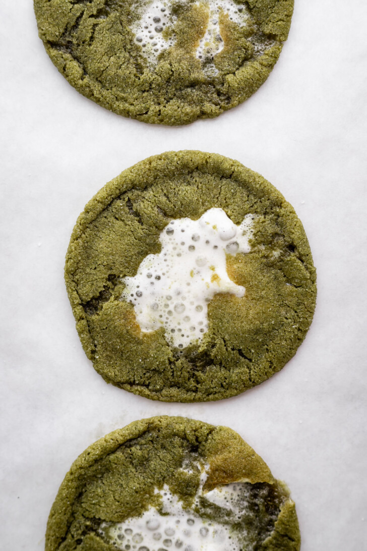 Baked matcha hot chocolate cookies on a baking sheet.