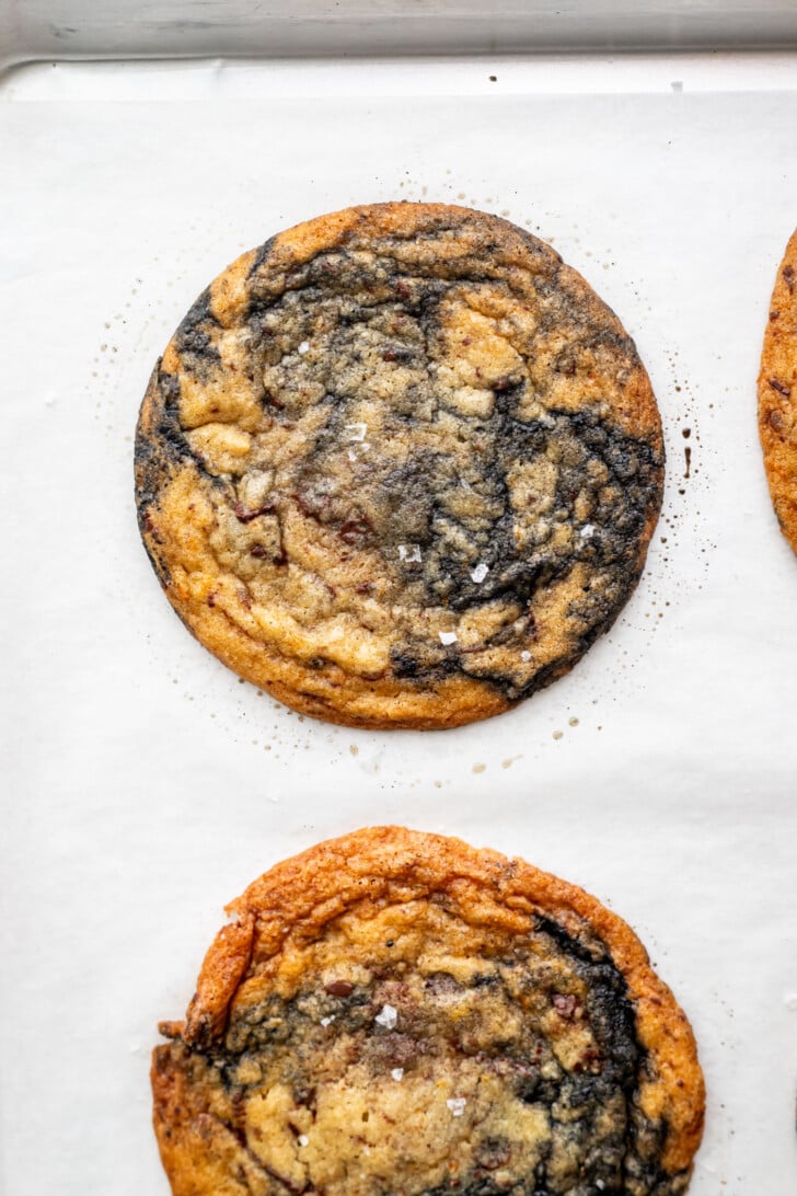 Baked orange black sesame cookies on a baking sheet.