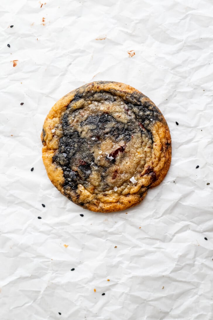 Orange black sesame cookie on parchment paper.