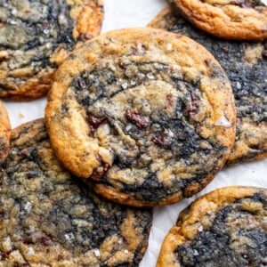 Orange black sesame cookies on parchment paper.