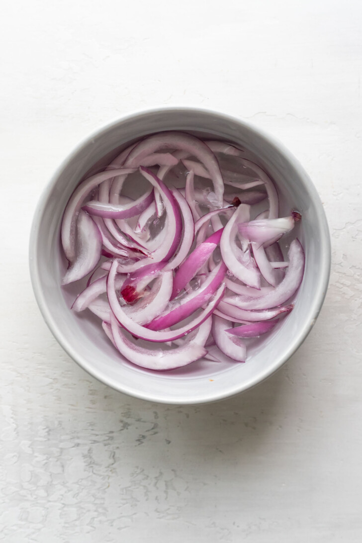 Soaking red onion in water.