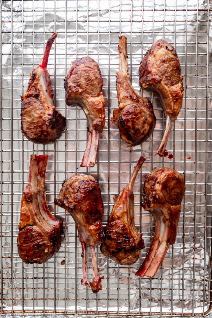 Lamb chops on a baking sheet.