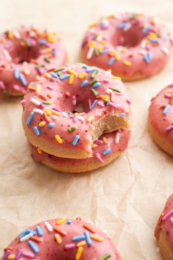 Strawberry mochi donuts on parchment paper.