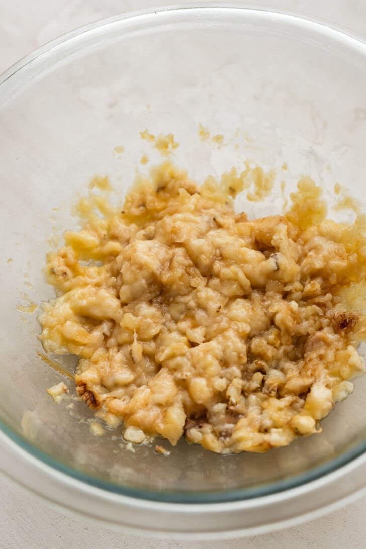 Mashed bananas in a mixing bowl.