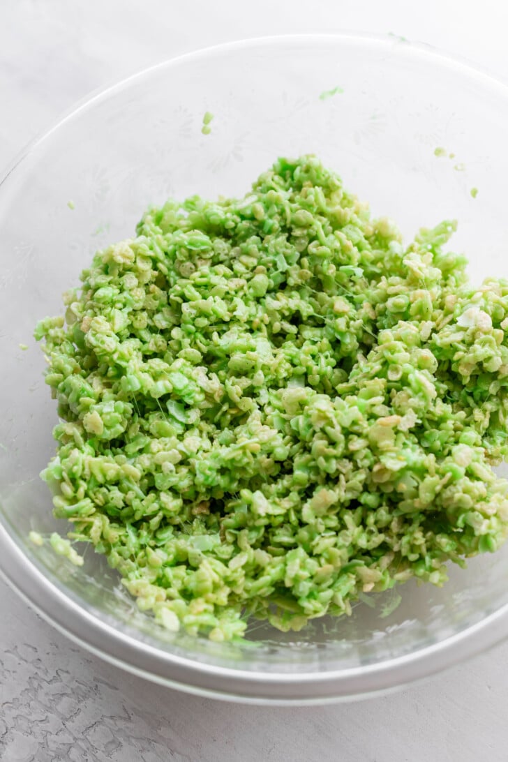 A glass bowl filled with pandan coconut rice krispie treats